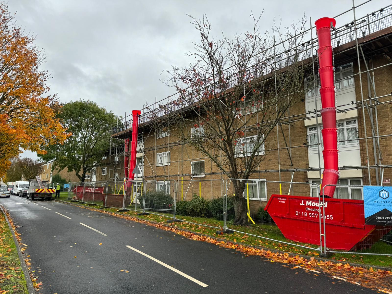 Roof-level scaffolding along a residential building